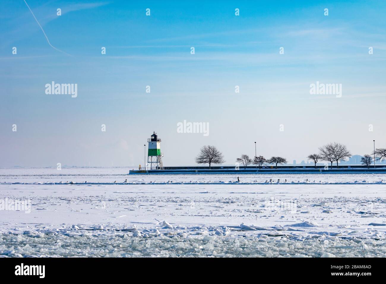 Lighthouse on a Frozen Lake Michigan in Chicago after a Polar Vortex Stock Photo