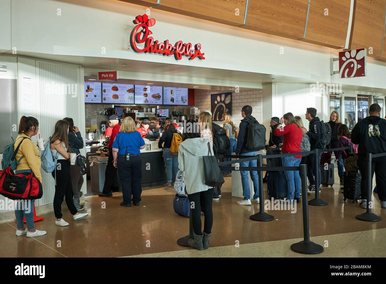 Passengers waiting in line at a Chick-fil-A restaurant in San Jose International Airport, seen on Thursday, Feb 13, 2020. Stock Photo
