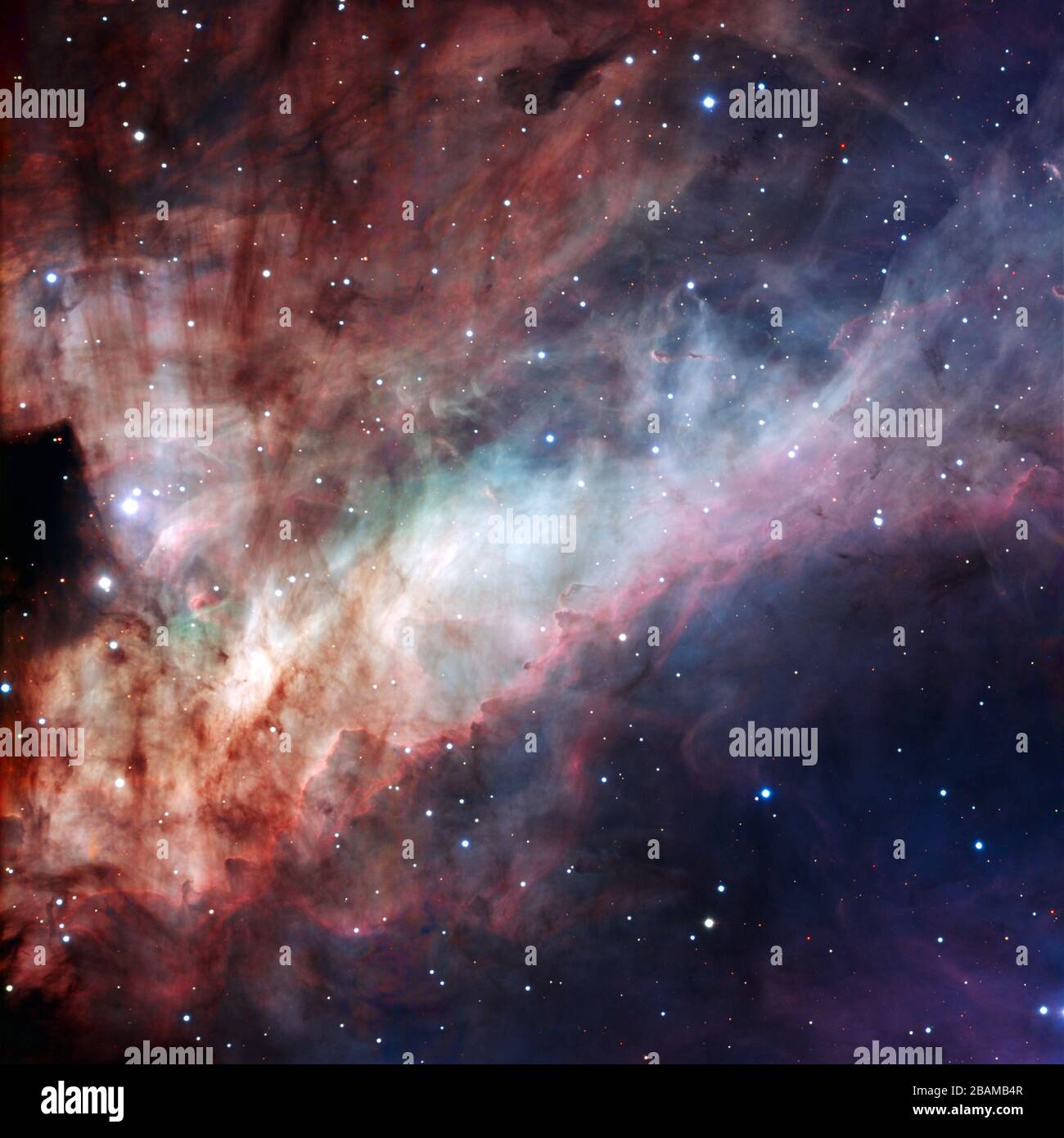 'English: Three-colour composite image of the Omega Nebula (Messier 17, or NGC 6618), based on images obtained with the EMMI instrument on the ESO 3.58-metre New Technology Telescope at the La Silla Observatory. North is down and East is to the right in the image. It spans an angle equal to about one third the diameter of the Full Moon, corresponding to about 15 light-years at the distance of the Omega Nebula. The three filters used are B (blue), V (visual, or green) and R (red).; 7 July 2009 (released); http://www.eso.org/public/images/eso0925a/ (direct link); European Southern Observatory; ' Stock Photo
