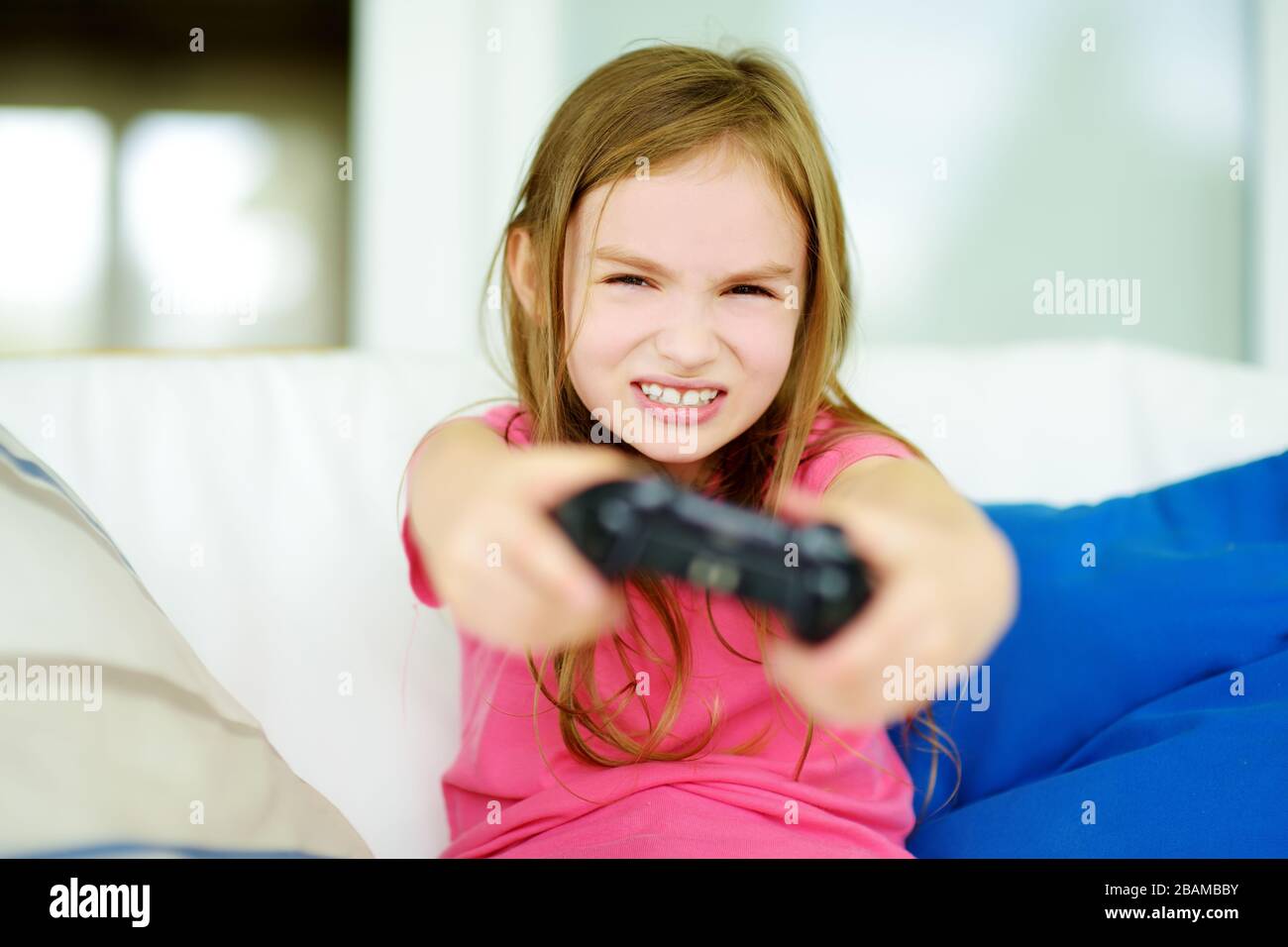 Funny little girl playing with game console at home. Child having fun in  front of the TV. Kid playing video games. Family leisure. Stay at home  entert Stock Photo - Alamy