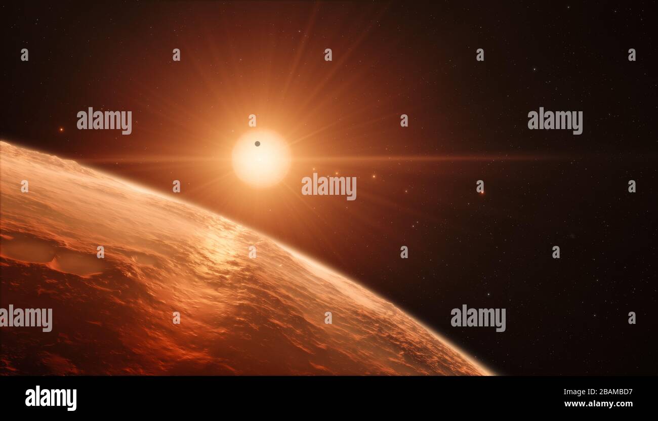 'English: This artist’s impression shows the view from the surface of one of the planets in the TRAPPIST-1 system. At least seven planets orbit this ultra cool dwarf star 40 light-years from Earth and they are all roughly the same size as the Earth. They are at the right distances from their star for liquid water to exist on the surfaces of several of them. This artist’s impression is based on the known physical parameters for the planets and stars seen, and uses a vast database of objects in the Universe.; 22 February 2017, 19:00:00; https://www.eso.org/public/images/eso1706a/; ESO/N. Bartman Stock Photo