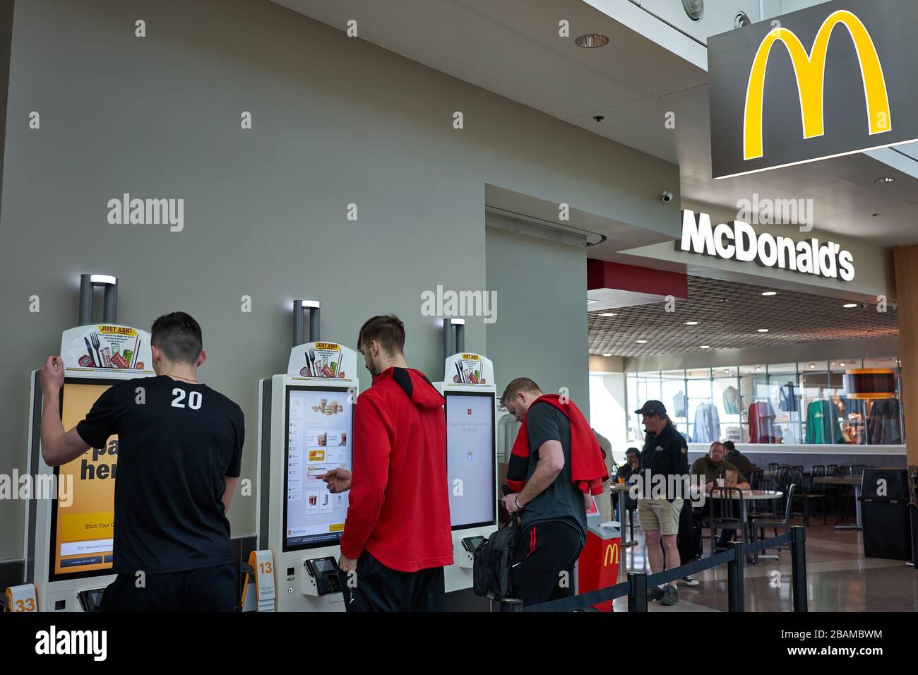 Customers use self service kiosks to place their orders at a McDonald's Restaurant in Portland International Airport on Sunday, Feb 23, 2020. Stock Photo