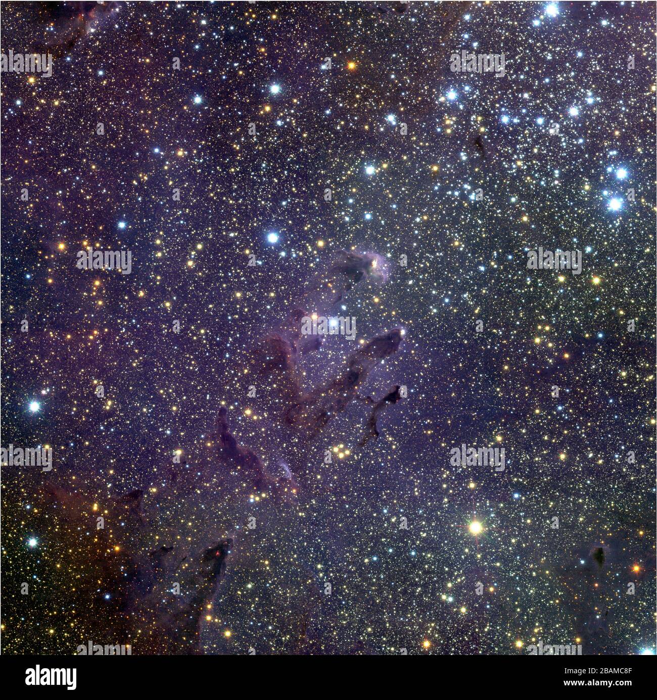 'English: Messier 16 (M16), also known as the Eagle Nebula, is located in the southern constellation of Serpens. Using the infrared multi-mode ISAAC instrument on the 8.2-m VLT ANTU telescope, European astronomers were able to image the Eagle Nebula at near-infrared wavelength. The ISAAC near-infrared images cover a 9 x 9 arcmin region, in three broad-band colours and with sufficient sensitivity to detect young stars of all masses and - most importantly - with an image sharpness as good as 0.35 arcsec. The wide-field view of M16 shows that there is much happening in the region. The first impre Stock Photo