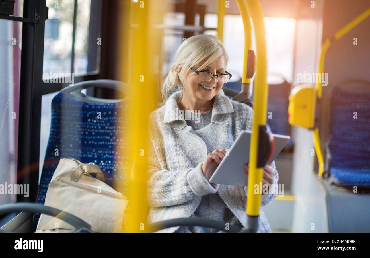 Senior woman in the bus Stock Photo