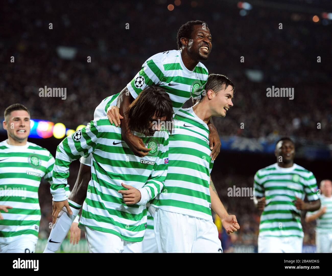 Celtic's Giorgos Samaras (left), Efe Ambrose (centre) and Mikael Lustig celebrate after Barcelona's Javier Mascherano scores and own-goal to give Celtic the first goal of the game Stock Photo