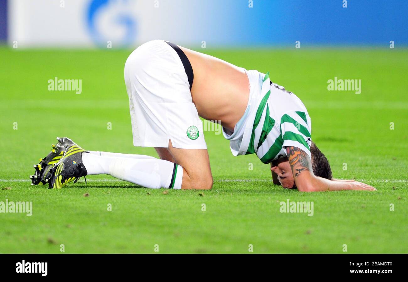 Celtic's Mikael Lustig on his hands and knees at the final whistle Stock Photo