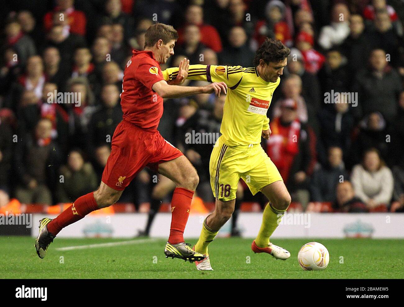 Anzhi Makhachkala's Yury Zhirkov and Liverpool's Steven Gerrard (left) battle for the ball Stock Photo