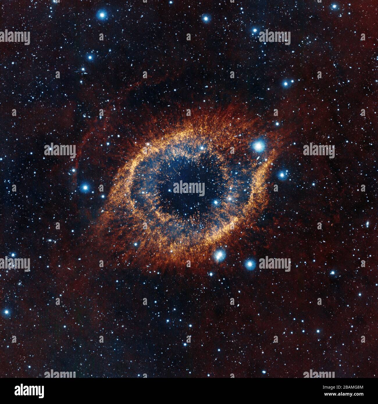 'English: ESO's Visible and Infrared Survey Telescope for Astronomy (VISTA) has captured this unusual view of the Helix Nebula (NGC 7293), a planetary nebula located 700 light-years away. The coloured picture was created from images taken through Y, J and K infrared filters. While bringing to light a rich background of stars and galaxies, the telescope's infrared vision also reveals strands of cold nebular gas that are mostly obscured in visible images of the Helix.; 19 January 2012, 12:00:00; http://www.eso.org/public/images/eso1205a/; ESO/VISTA/J. Emerson; ' Stock Photo