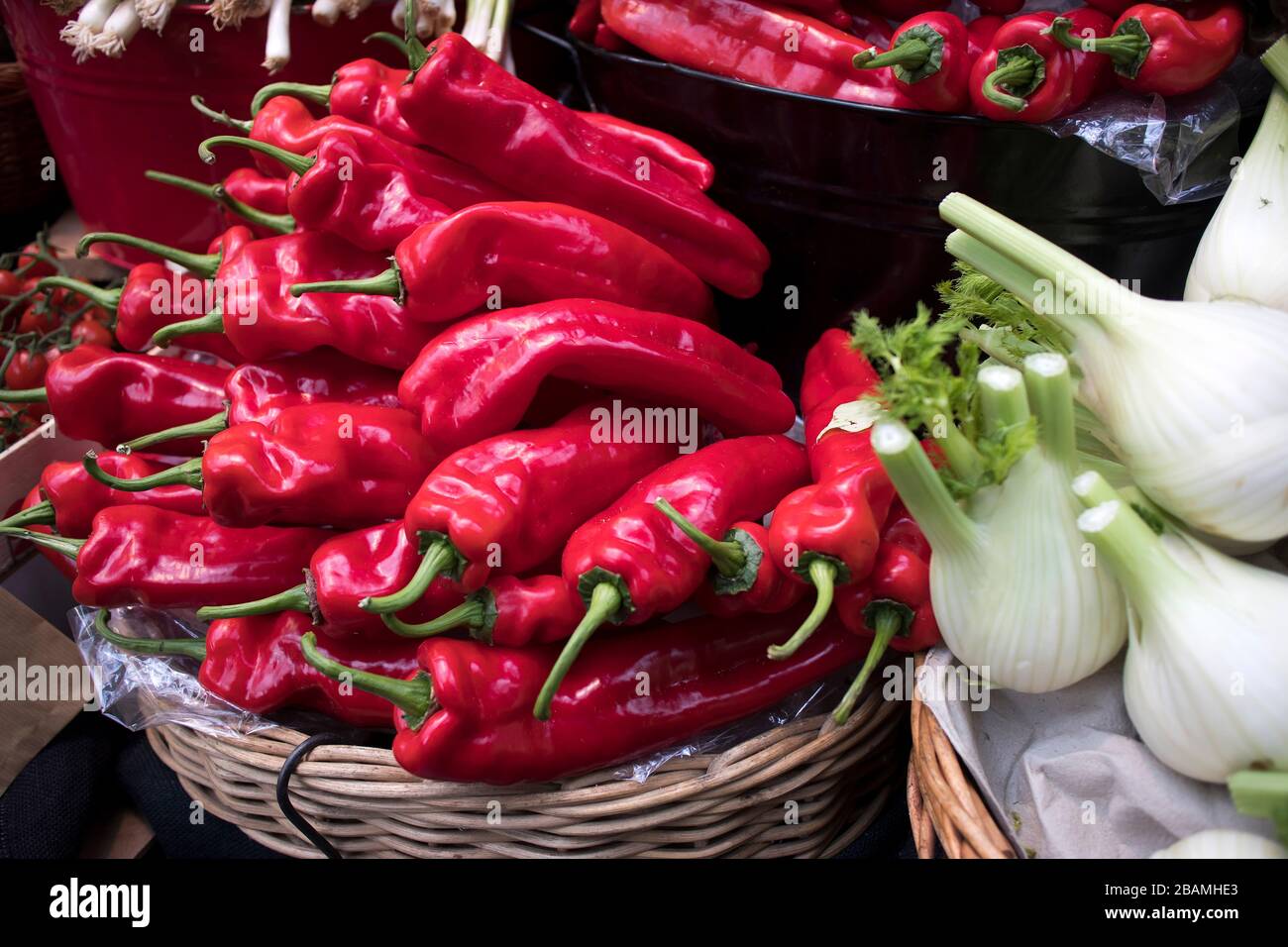 Red peppers falling out of a wicker basket as a decoration of the ...