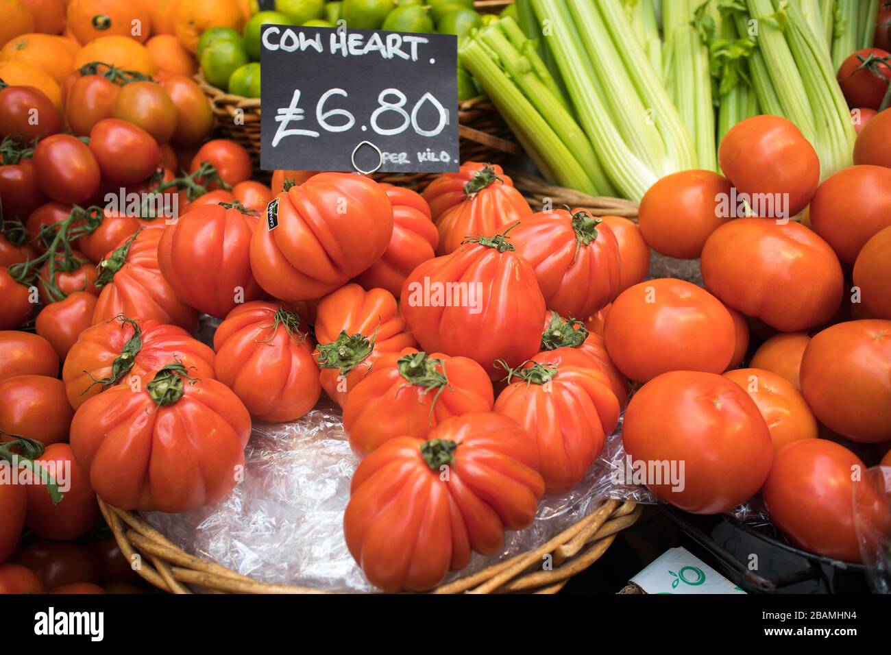 Large cow heart tomatoes for sale on a farmers market stall Stock Photo ...