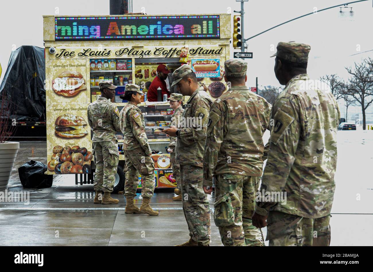 New York Manhattan, USA. 28th Mar, 2020. Army National Guard on the line to buy NYC hot dog out side the The Javits Convention Center. New York Gov. Andrew Cuomo announced the construction of a temporary hospital at the the Jacob K. Javits Center had been completed with the help of FEMA and the National Guard. New York State has over 26,000 cases and 450 people died from the pandemic in NYS in the past 24 hours. 03/28/20. New York Manhattan. Marcus Santos. Credit: Marcus Santos/ZUMA Wire/Alamy Live News Stock Photo