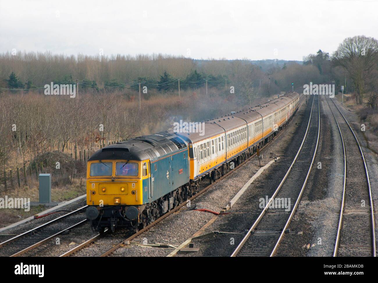 A class 47 diesel locomotive number 47840 working a train of former southern region electric multiple units for scrapping at Lower Basilon. Stock Photo