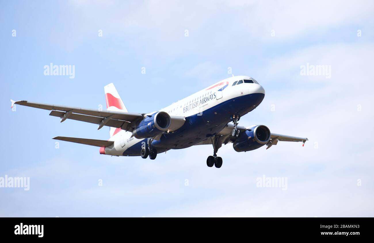 A British Airways airbus A319-131 callsign G-DBCA comes into land at Gatwick Airport, one of only a few flights landing during the Covid-19 pandemic. Stock Photo