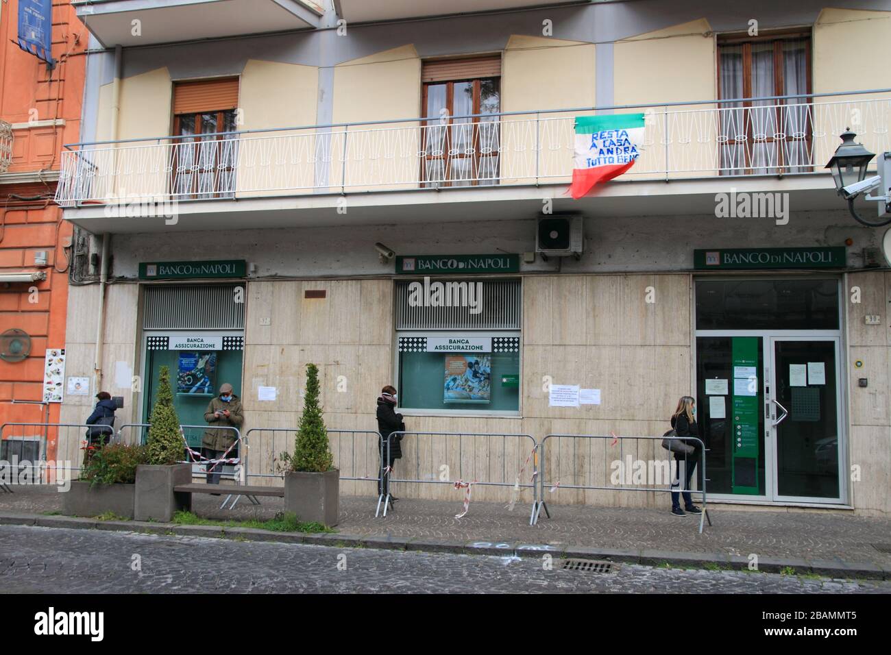 Pagani,Sa,Italy - March 28,2020 :Persons queuing outside the Italian Post Office to be able to pick up their pension or pay bills respecting the secur Stock Photo