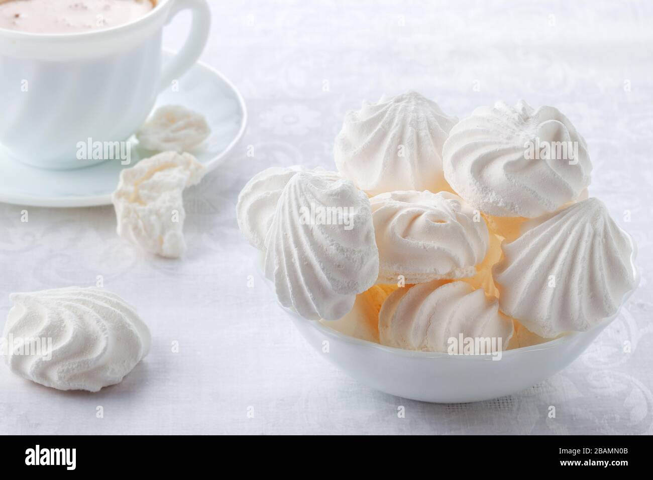 Tender, airy Bizet and a cup of fresh coffee with cream Stock Photo