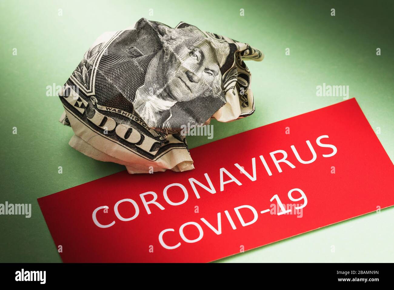 Crumpled dollar and tag with text. Concept on the impact of the COVID-19 pandemic on the US currency Stock Photo