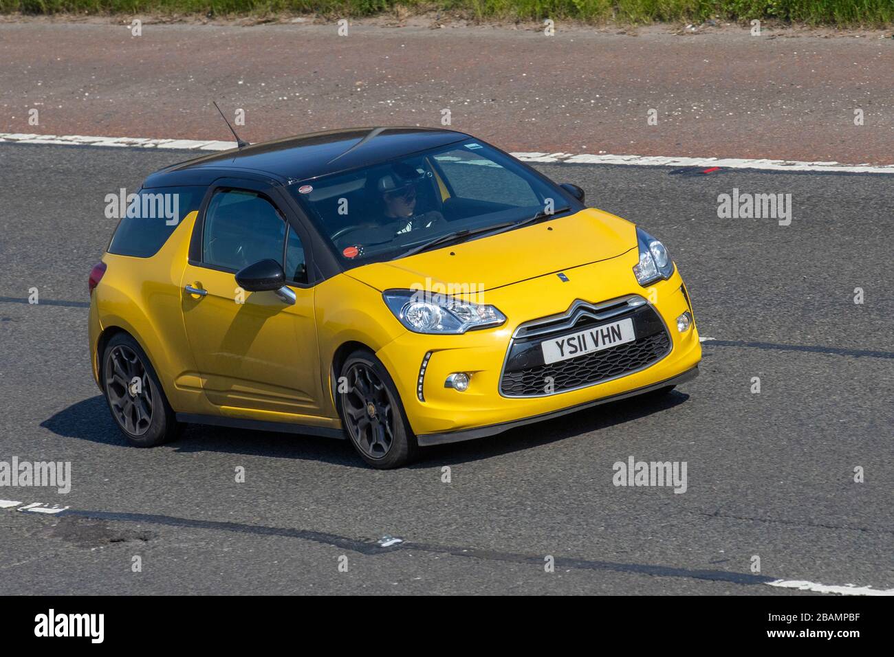 2011 yellow Citroën DS3 D style +; moving vehicles, vehicle driving, roads, motors, motoring  on the M6 motorway highway Stock Photo