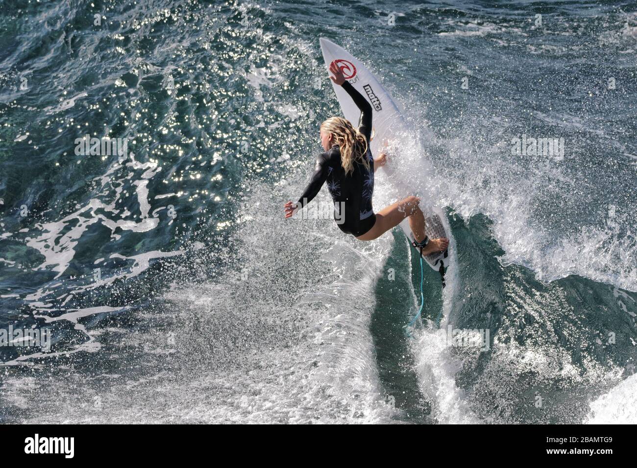 Pro surfer, Evelinne Hooft pracicing surfing at Honolua Bay on Maui. Stock Photo