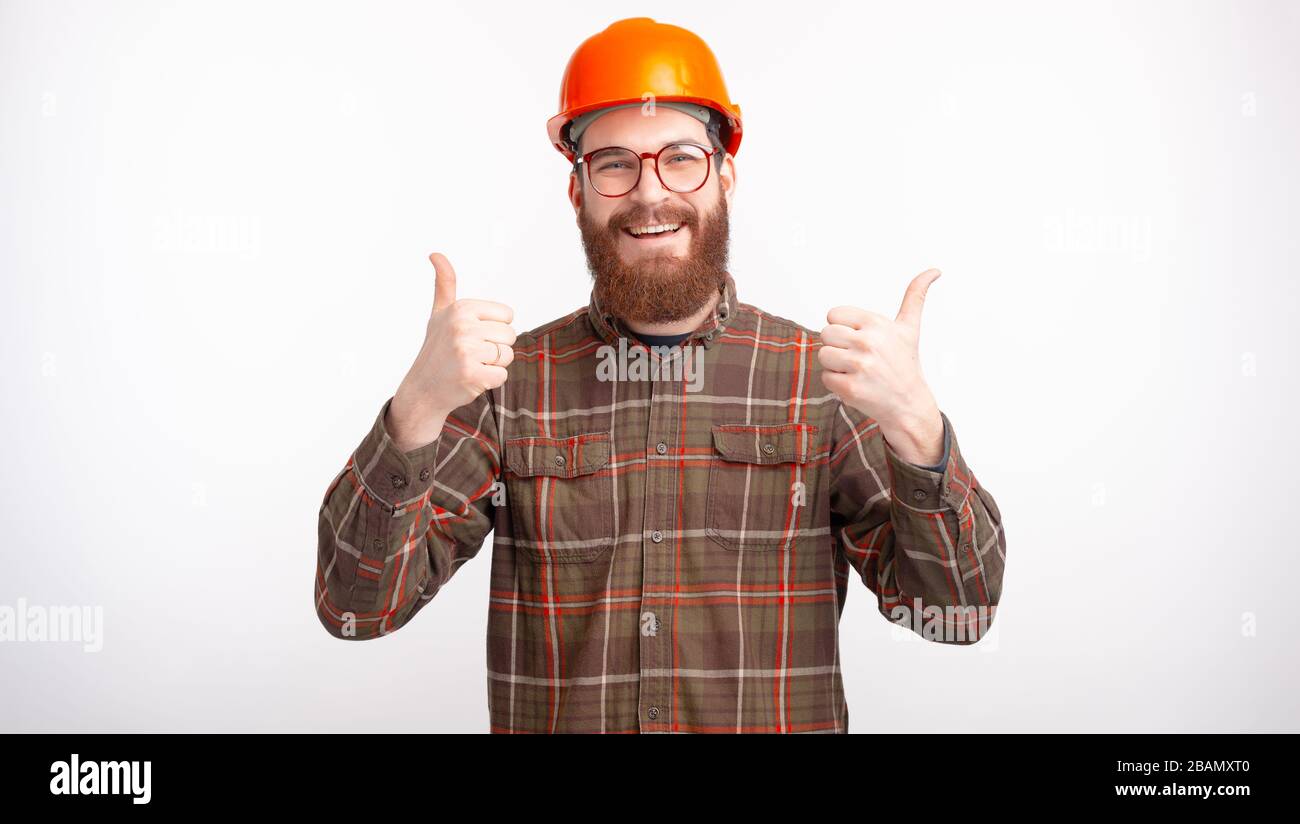 I like my job. Happy bearded man is making like gesture or thumbs up