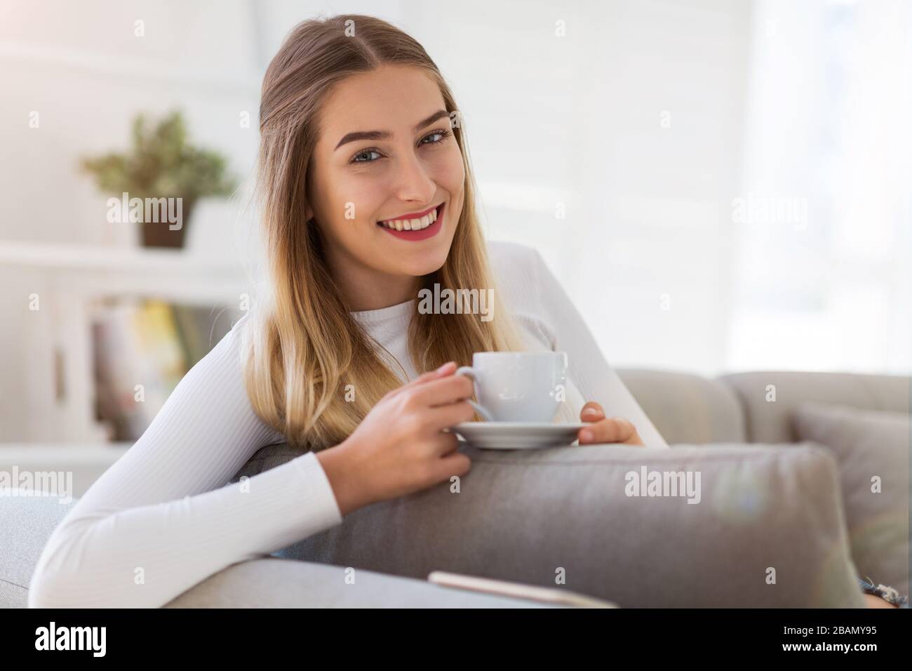 Portrait of a woman relaxing at home Stock Photo - Alamy