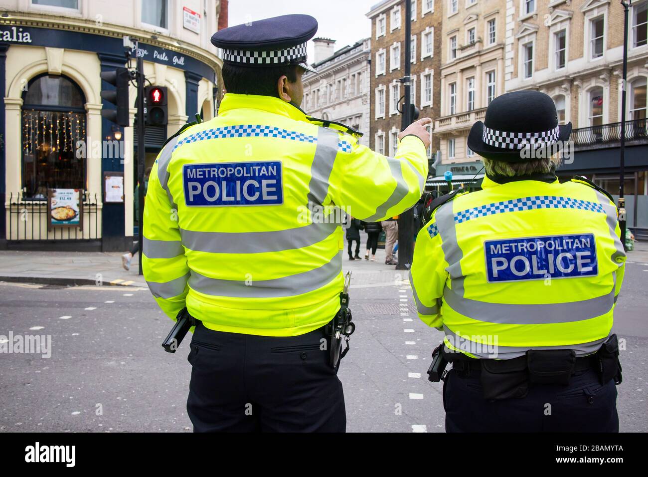 London, UK - 12 March, 2020 , Police are patrolling the city. View of the police from the back. Stock Photo