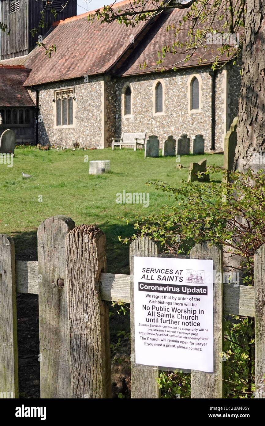 Notice fixed to gate All Saints Church Doddinghurst informs churchgoers that public worship is cancelled not permitted because of Coronavirus virus UK Stock Photo