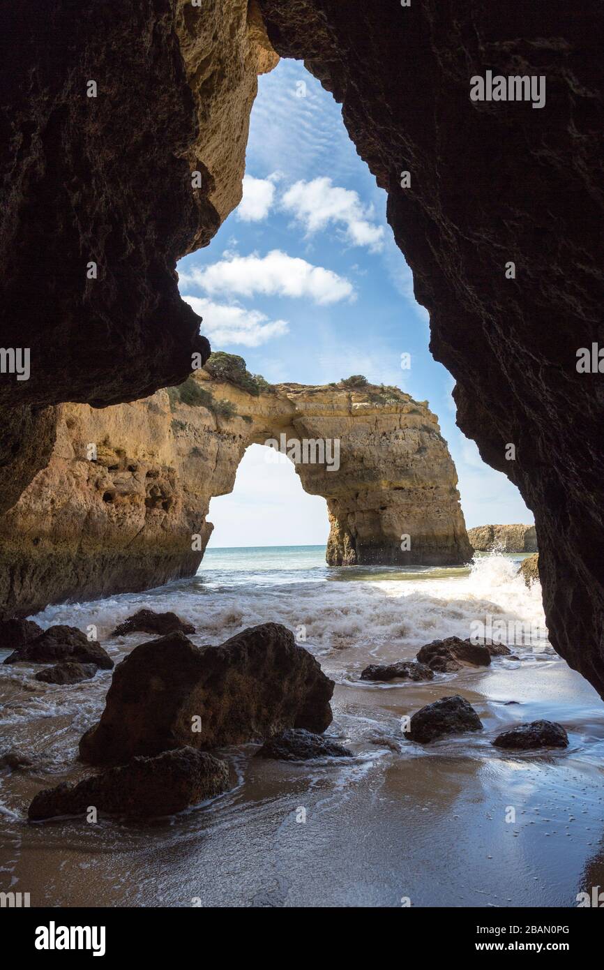 Sea cave and arch on coast west of Alporchinhas, Algarve, Portugal Stock Photo