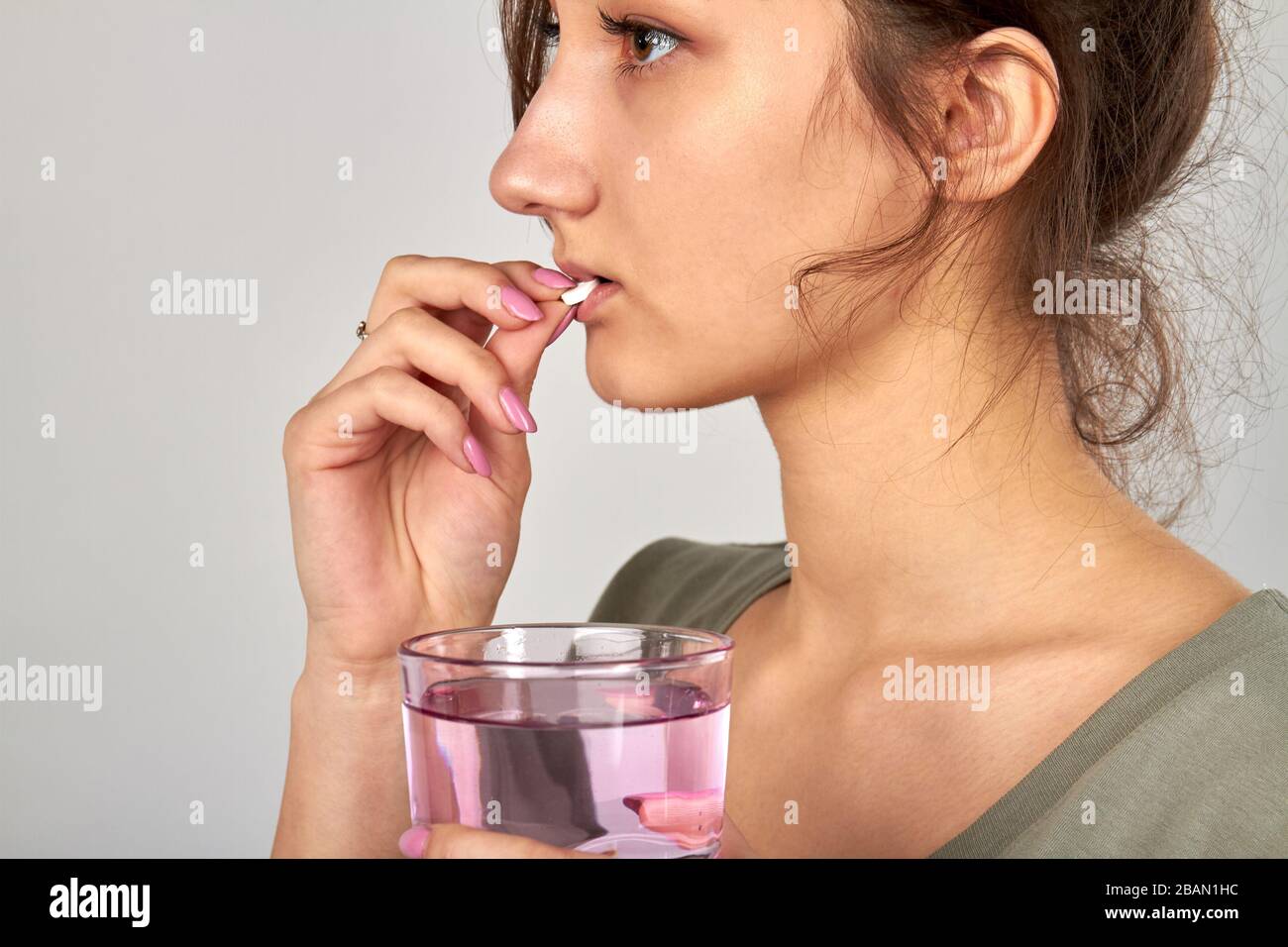Young girl taking pill to cure flu. Stock Photo