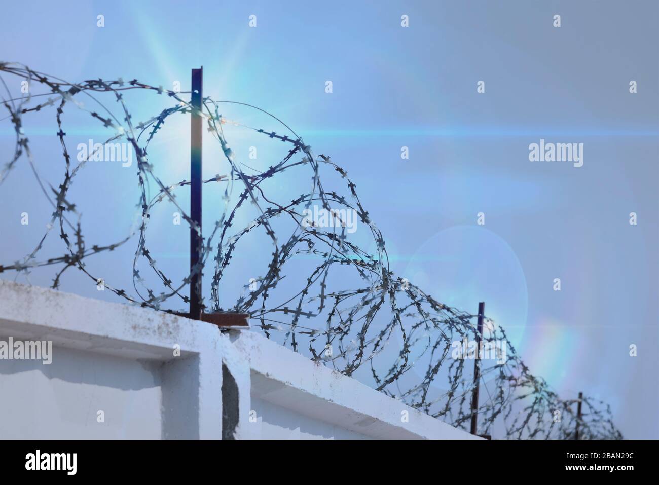 Barbed wire fence against the blue sky Stock Photo - Alamy