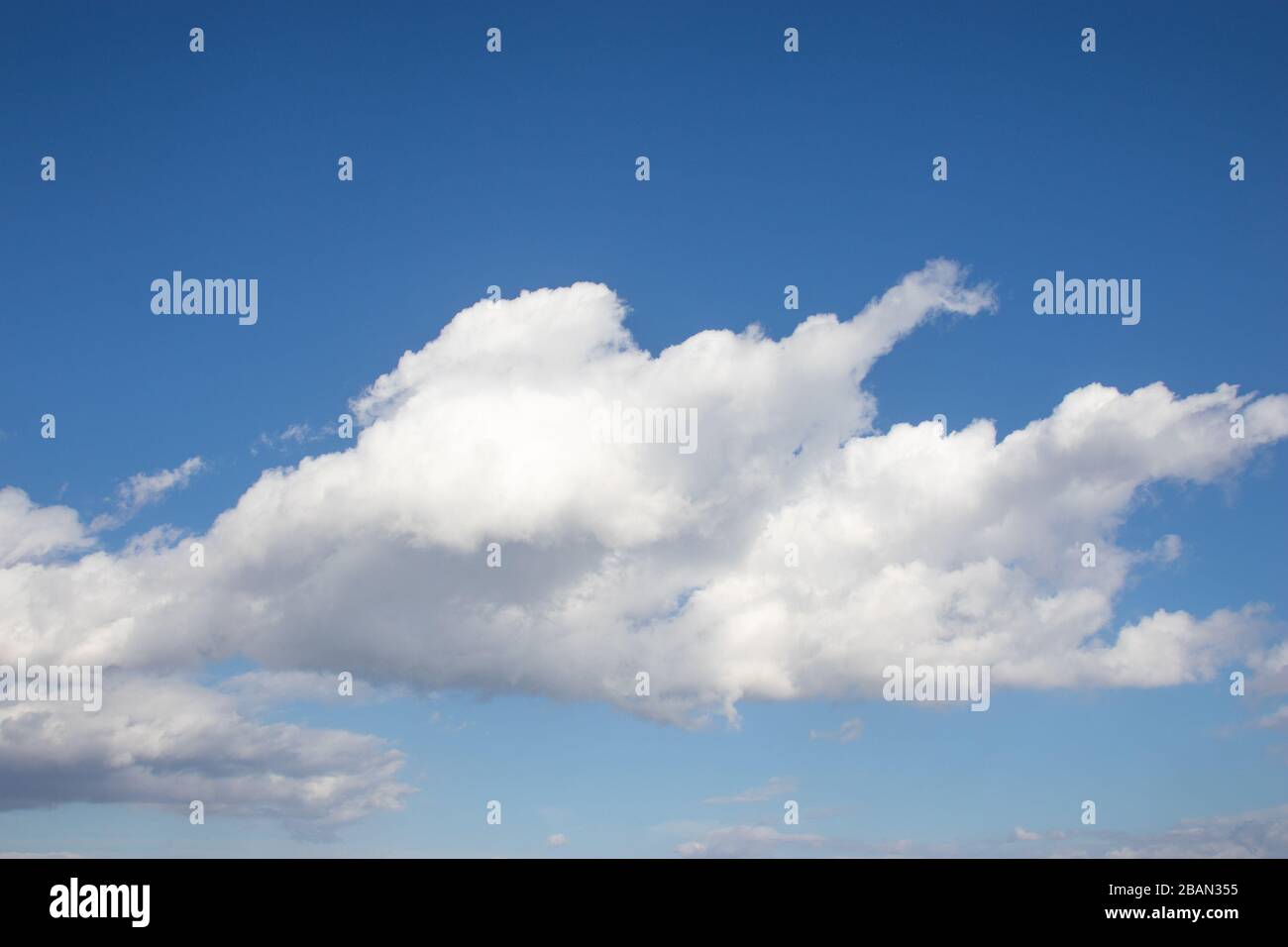 White fluffy clouds on bright blue sky Stock Photo