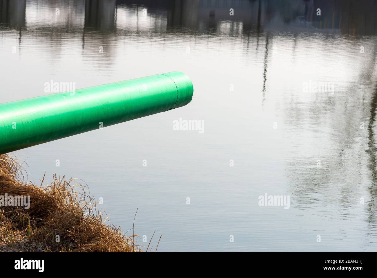 A drain pipe or sewage or sewage discharges waste water into a river. Wastewater or domestic wastewater or municipal wastewater that is a product of a Stock Photo