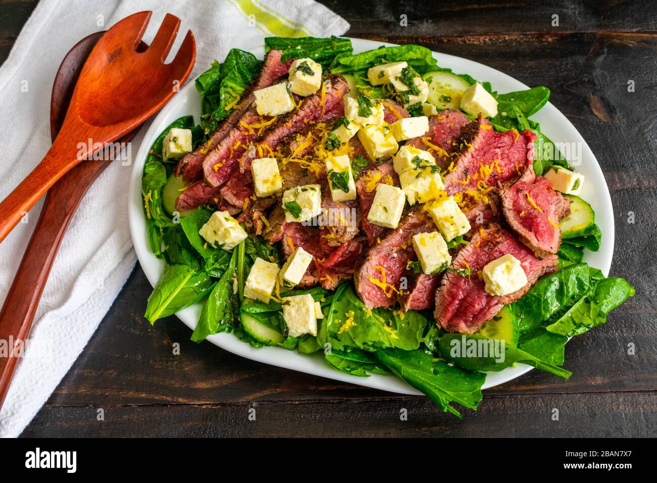 Steak and Feta Salad Spinach and fresh herb salad topped with rare