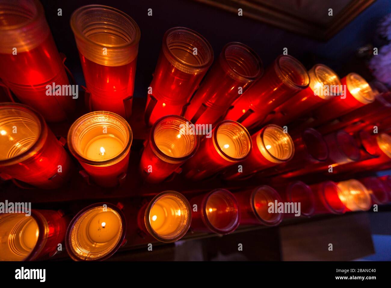 Red prayer candles lit in rows catholic church Stock Photo Alamy