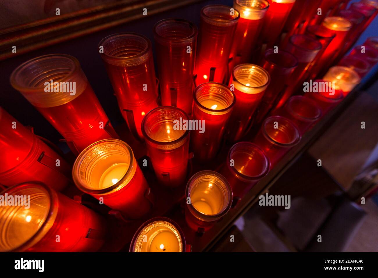 Red prayer candles lit in rows catholic church Stock Photo Alamy