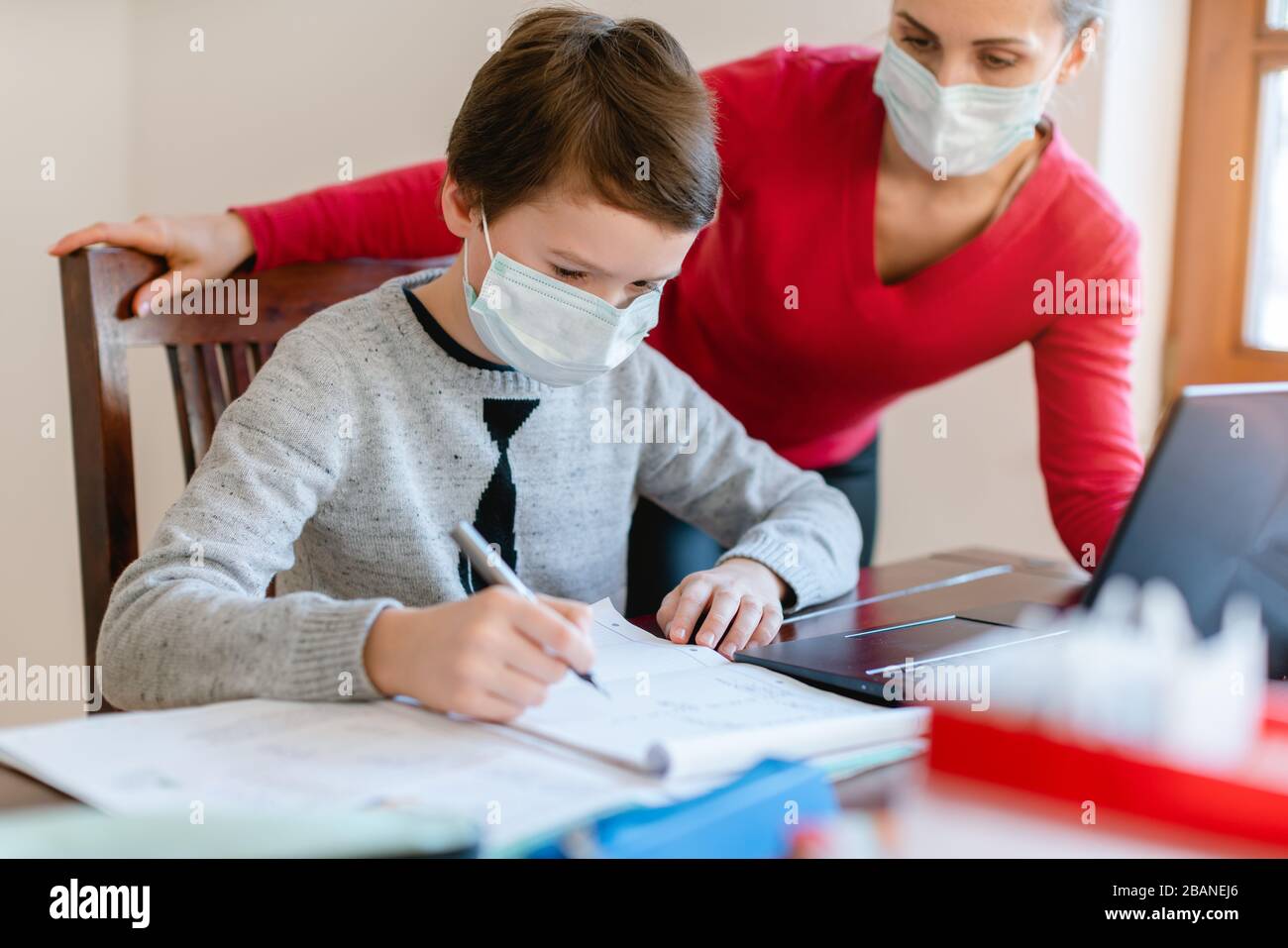 School student learning in video chat with teacher in e-learning Stock Photo
