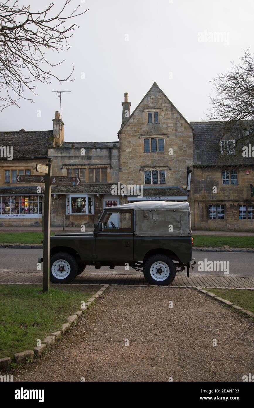 Green Land Rover Jeep on High Street, Broadway Village, Cotswolds, Gloucestireshire, England, WR12 7AL Stock Photo