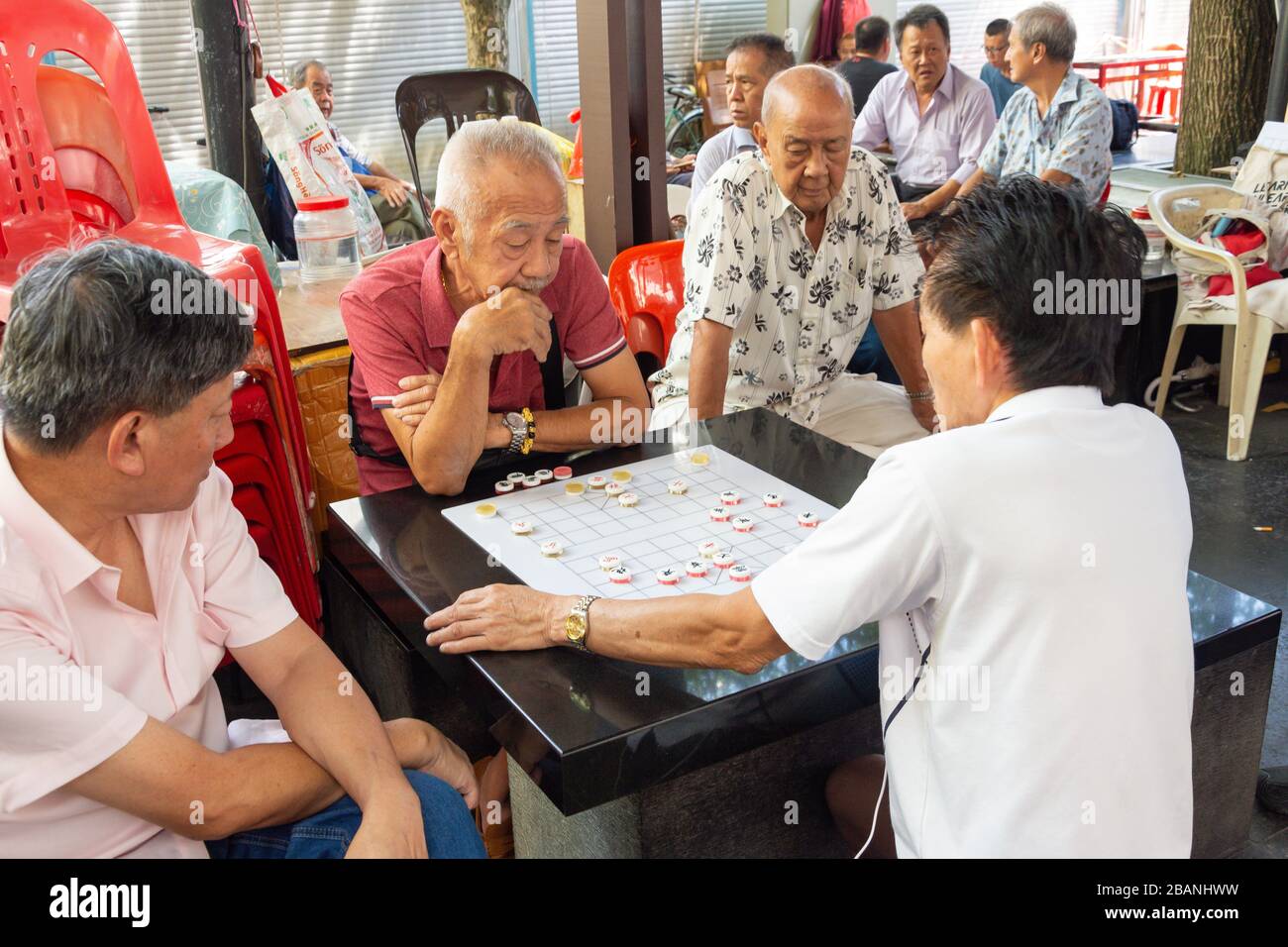 Local men playing Chinese chess (Xiangqi) board game, Sago Street, Chinatown, Central Area, Republic of Singapore Stock Photo