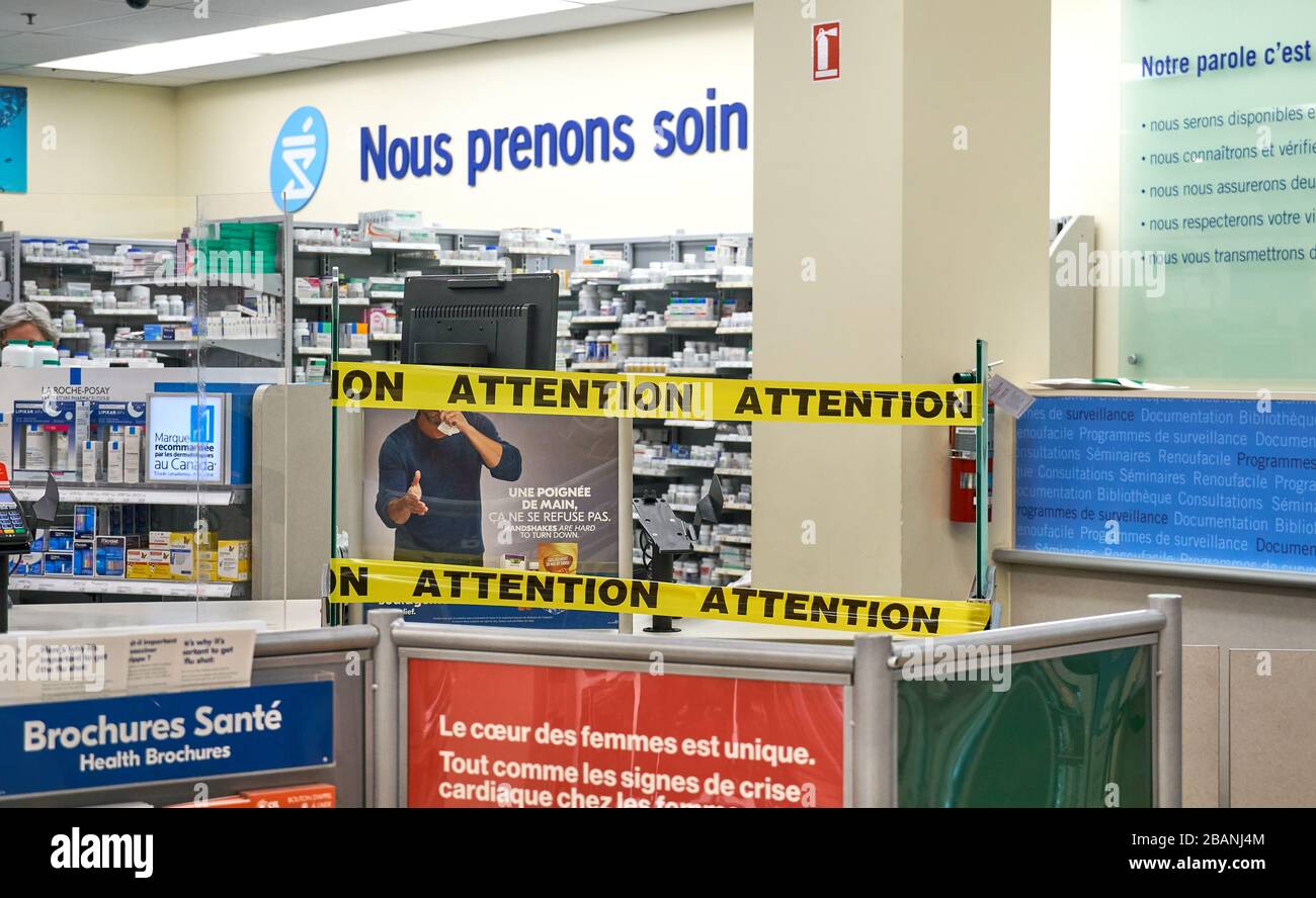 Montreal, Canada - March 28, 2020: Attention writing and tape at prescription section at Pharmacy. New procedure implemented in Quebec when people cop Stock Photo
