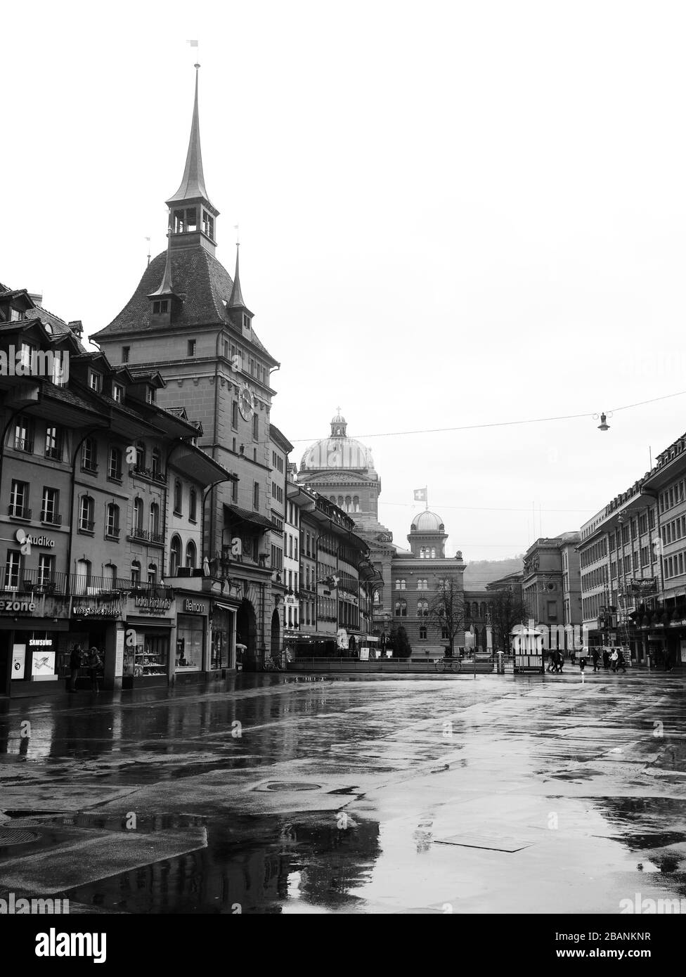 Black and white image of Medieval town, Bern in Switzerland with 17th-century Baroque clock and bell tower and parliament in the background. Stock Photo