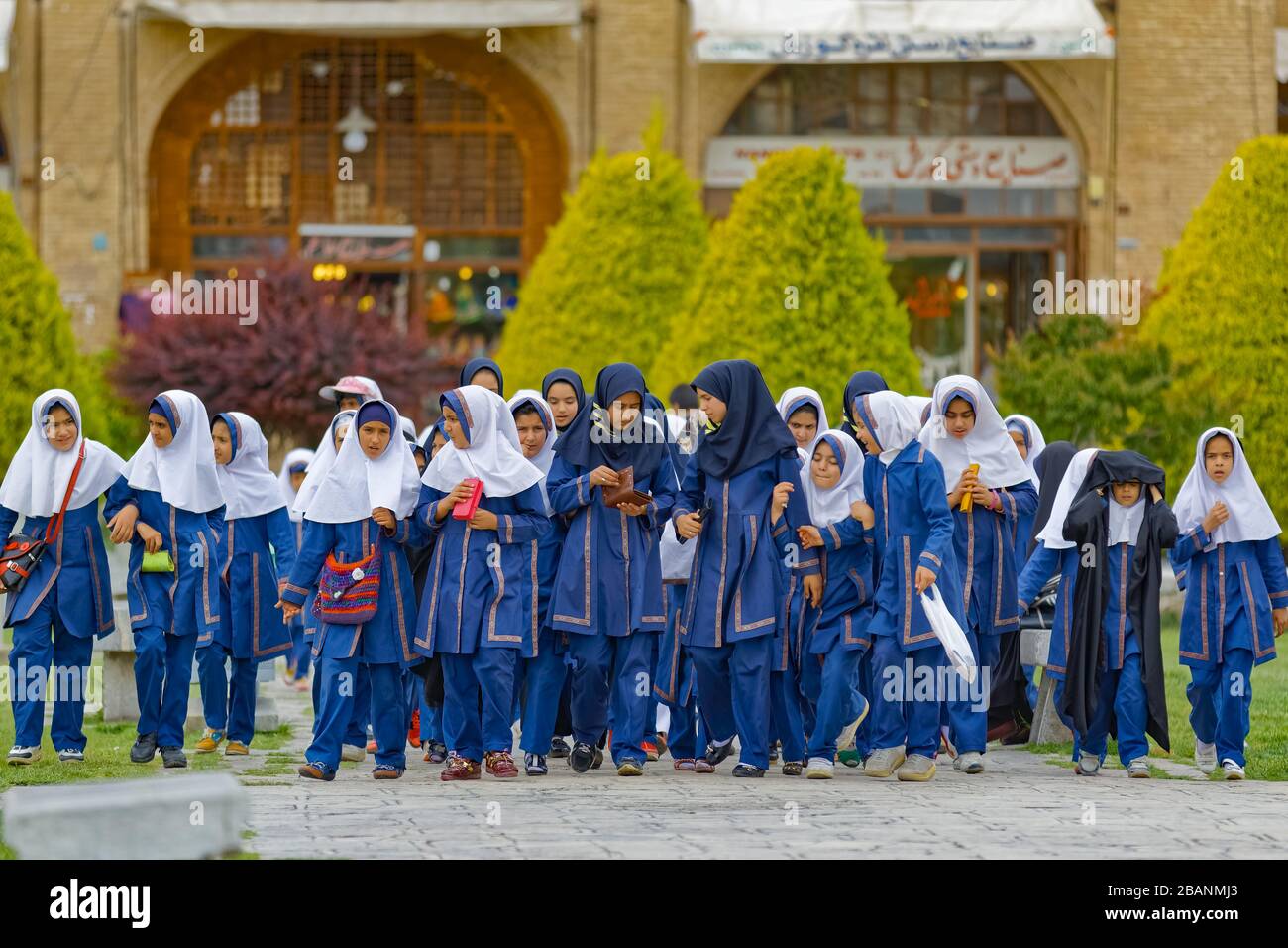 Elementary school girls on Imam Square in front of the Ali Qapu Palace in Isfahan Stock Photo