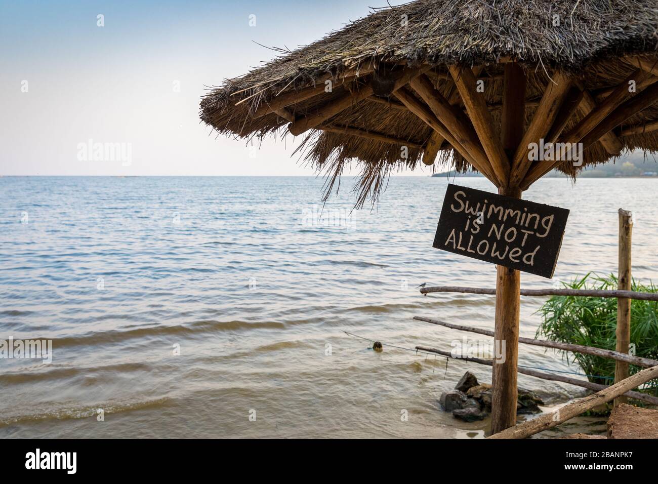 A sign warns no swimming allowed at 2 Friends beach resort, Lake Victoria, Uganda Stock Photo