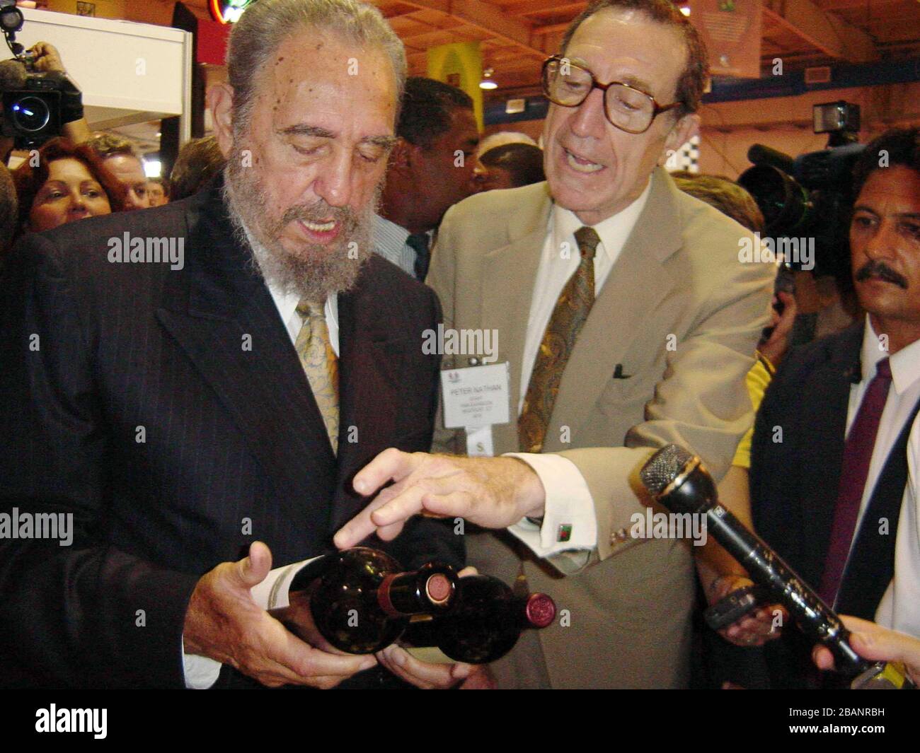 HAVANA, CUBA-SEPTEMBER 26 Cuban president Fidel Castro (L) talks with Peter Nathan of PWN Exhibicon International LLC, on September 26, 2002, during his visit to the Fair of Agricultural and North American managers' Cattleman. A group of top American food and agricultural executives with some 280 companies from 33 states hope to recover a lost market for U.S. food products as they push for further lifting of sanctions imposed on Cuba after Fidel Castro's 1959 revolution. Cuban officials expect to sign hundreds of contracts at the five-day food fair to attract more U.S. interest and encourage g Stock Photo