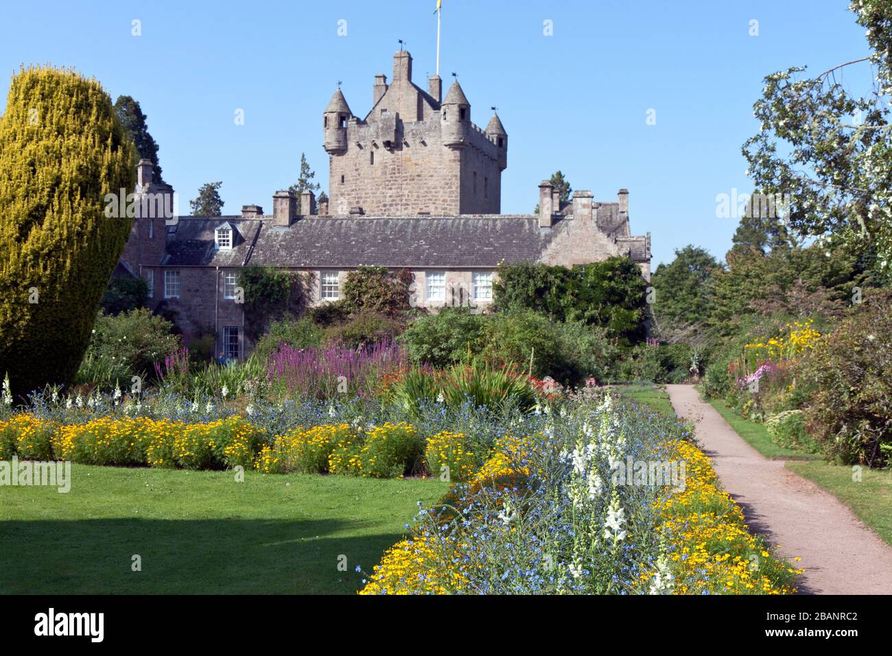 One of four gardens, this aptly-named Flower Garden bathes Cawdor Castle's 15th century tower house in brilliant color.  Owned and inhabited by the sa Stock Photo