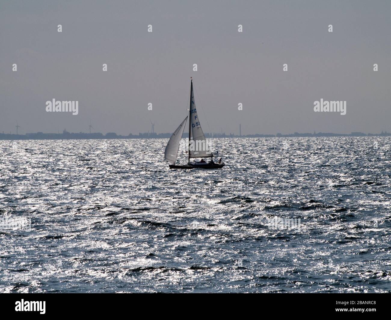 Nordisk Folkeboat cruising on the Oeresund between Denmark and Sweden. Stock Photo