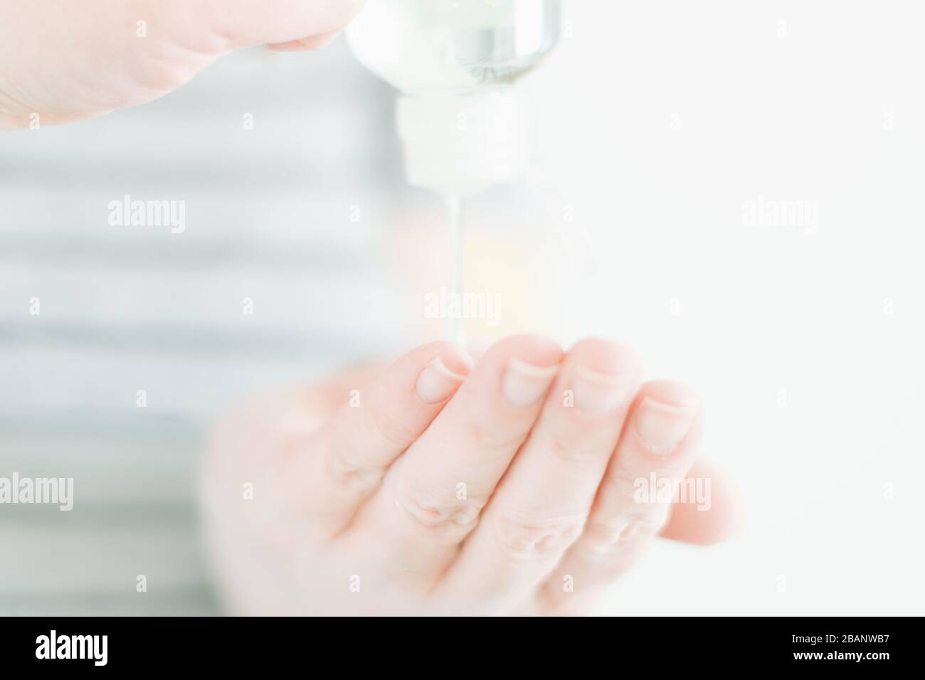 Woman using anti-bacterial gel (soft focus image) Stock Photo