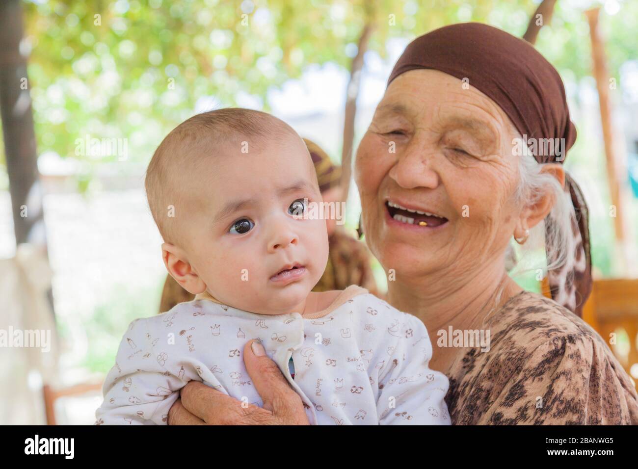 Grand mother and children, Derbent or Derbend, Surxondaryo Region, Uzbekistan, Central Asia, Asia Stock Photo
