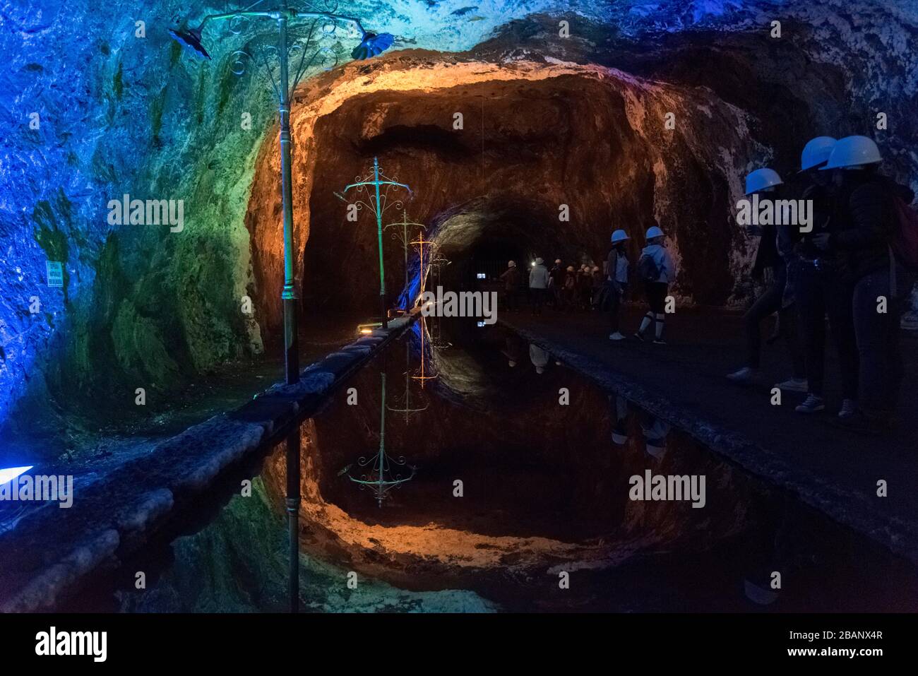 Nemocon, Cundinamarca / Colombia; March 24, 2018: mirror of water and walls illuminated with colored lights inside a salt mine Stock Photo