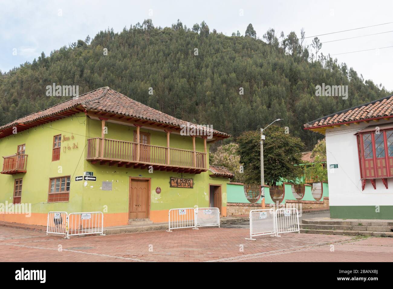Nemocon, Cundinamarca / Colombia; March 24, 2018: Exterior view of the Salt Museum, green construction, colonial type, with balconies. In the backgrou Stock Photo