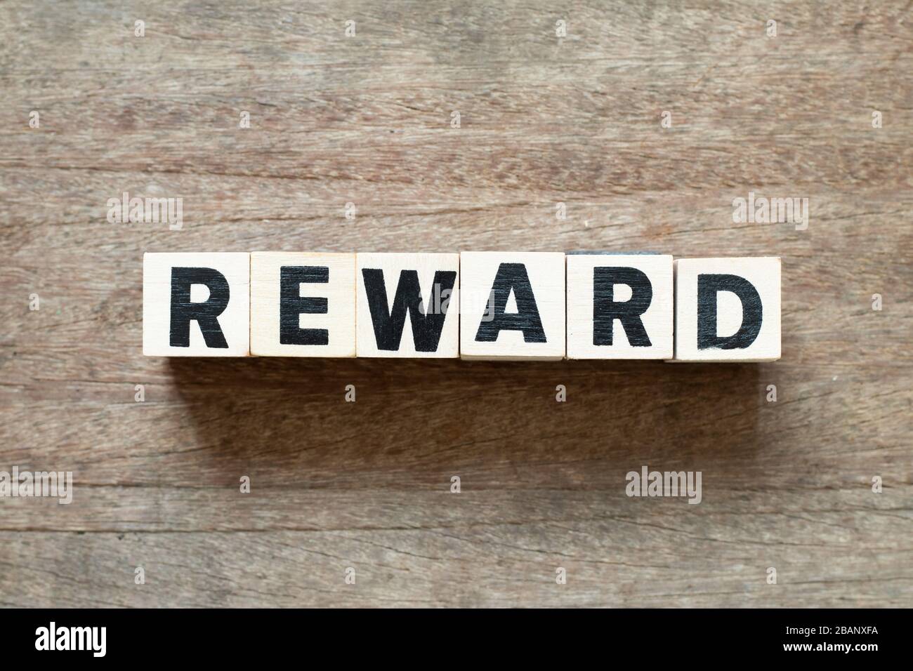 Letter block in word reward on wood background Stock Photo