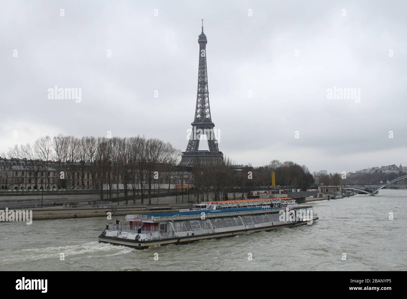 Boat sailing the Sena river with the Eiffel Tower in the background. Stock Photo